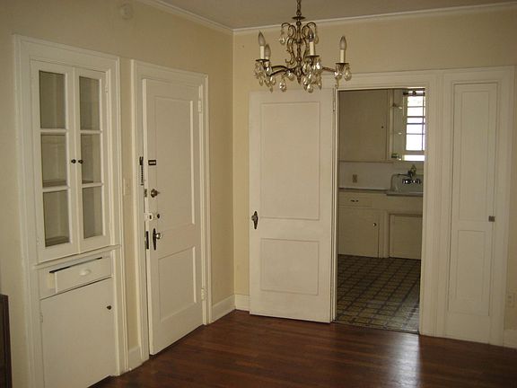Dining room has built-in hutch; built-in ironing board to right of kitchen