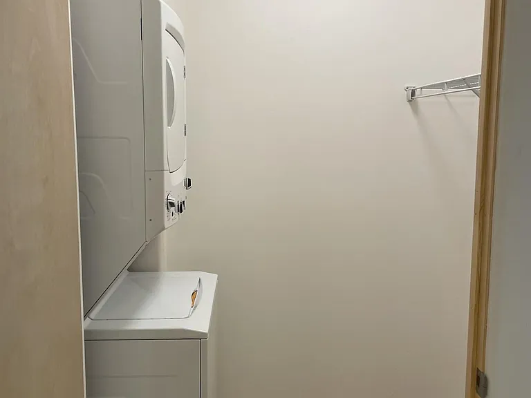 Laundry room in 3202 "The Edward" Loft can double as a closet for hanging more clothing.