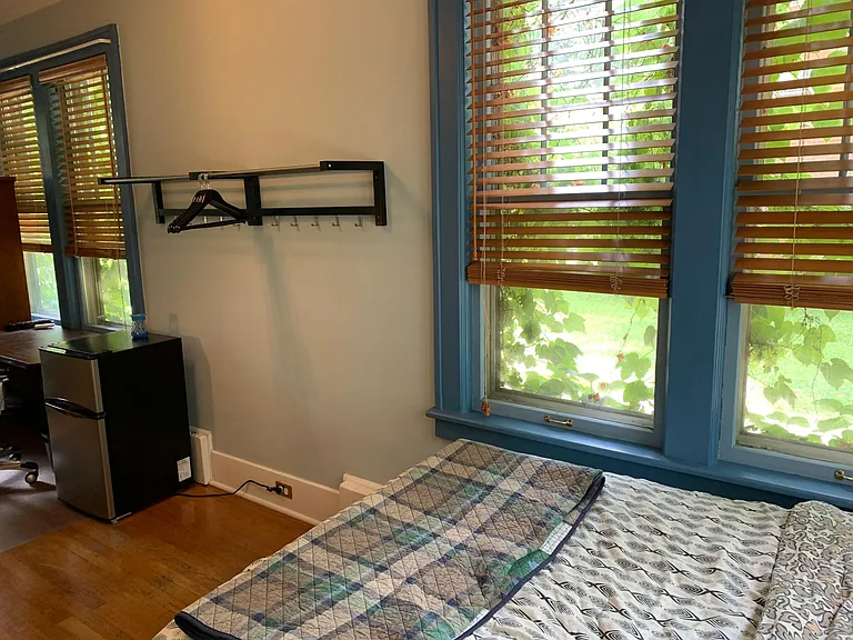 Private refrigerator and double bed with under bed storage provided.