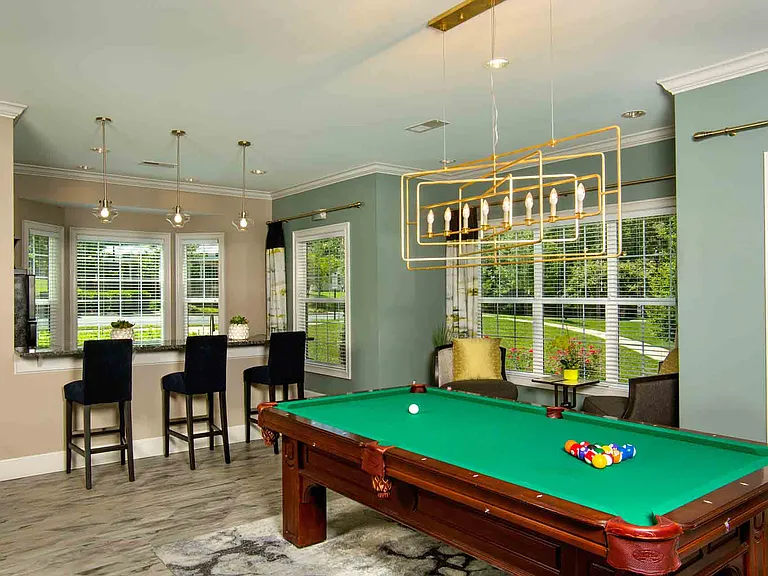 Entertainment lounge with pool table, games, and TVs