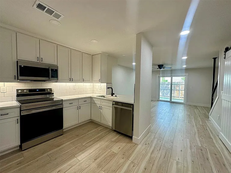 Kitchen opens up to living and dining areas. Living areas furnished, see other photos.