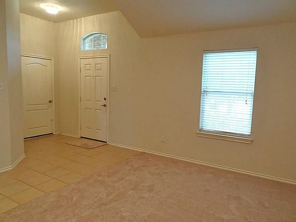 From the front door, step into a ceramic tiled entry.  Door to the left of the entry leads to the attached 2-car garage with an automatic garage door opener.