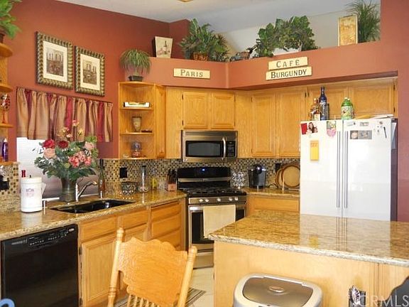 Gourmet Kitchen, granite counters, backsplash,stainless steel appliances, and upgraded sink.