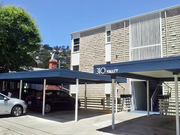 Carports in front of building.
