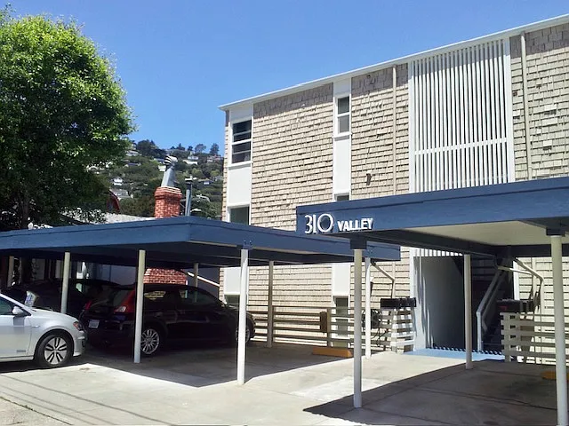 Carports in front of building.