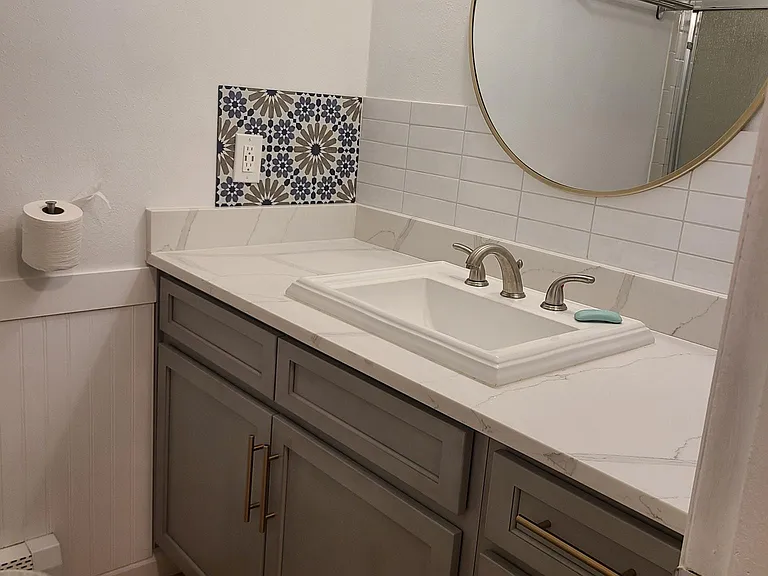 Quartz counter top, new vanity and cabinets, new backsplash, new toilet