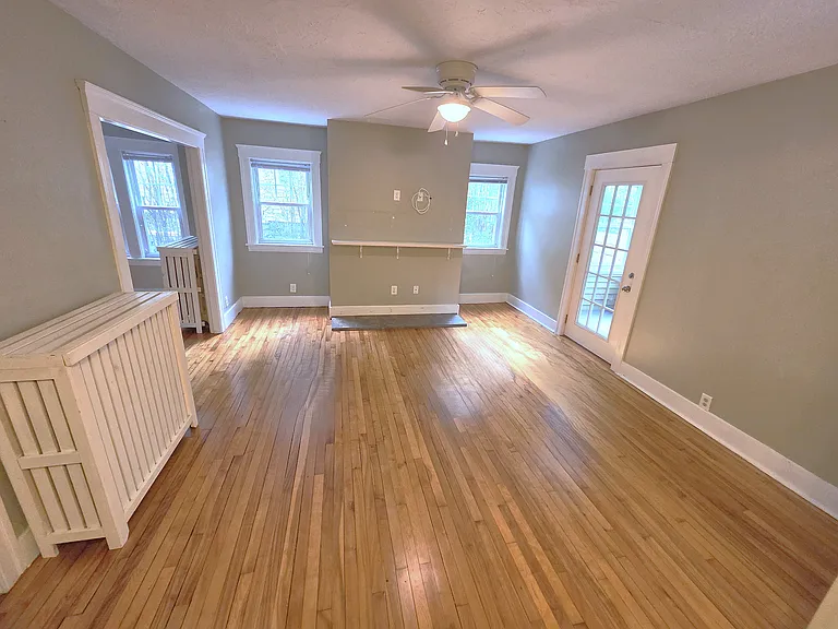 Spacious living room with hardwood floors and abundant natural light.