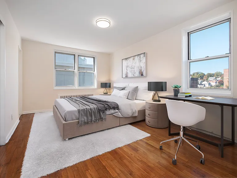 Elevate your lifestyle at 40 Barker Avenue. This bright, modern bedroom features ample natural light, stylish furnishings, and a dedicated workspace perfect for productivity. Ready to make this space your own? Inquire today!