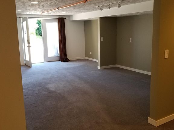 Front door and living room. Standing in kitchen.