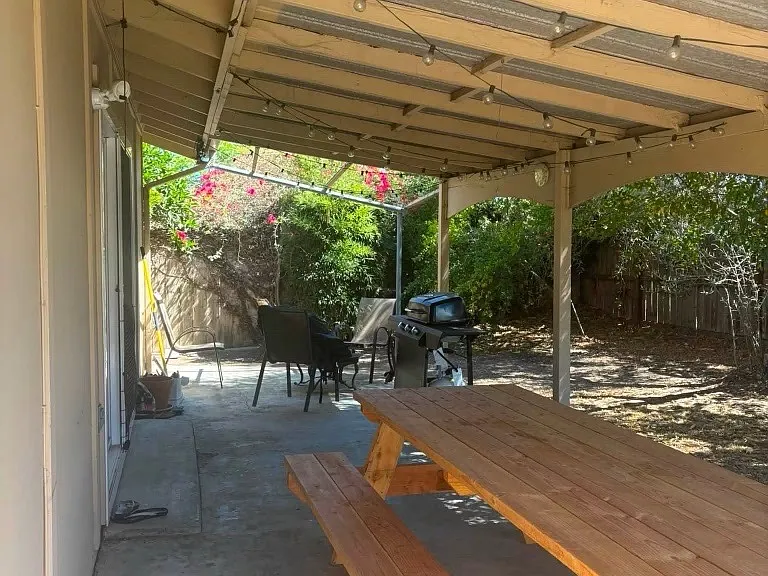 Backyard and patio space with grill, firepit, and picnic table
