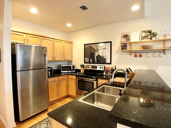 Spacious kitchen with refrigerator, oven, microwave and dish washer.