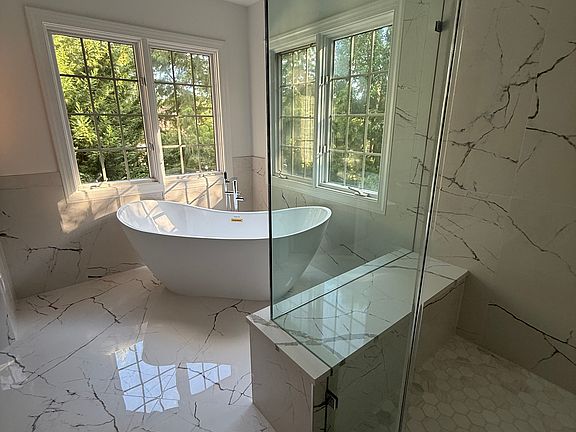 Spacious, light and just remodeled master bathroom with a free standing bathtub; spacious shower.