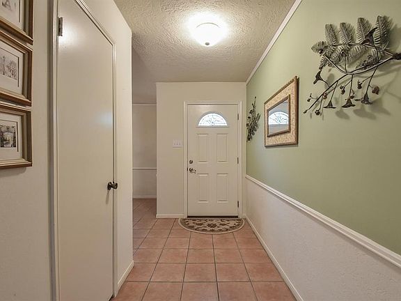 Tile flooring, chair rail across foyer. Handy closet for coats, etc.