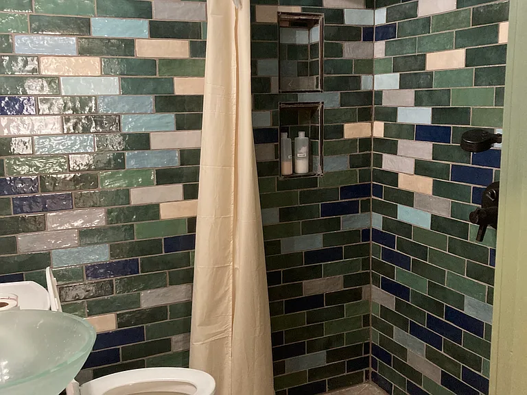 1st floor bathroom, wetroom with heated floors and multiple showerheads.