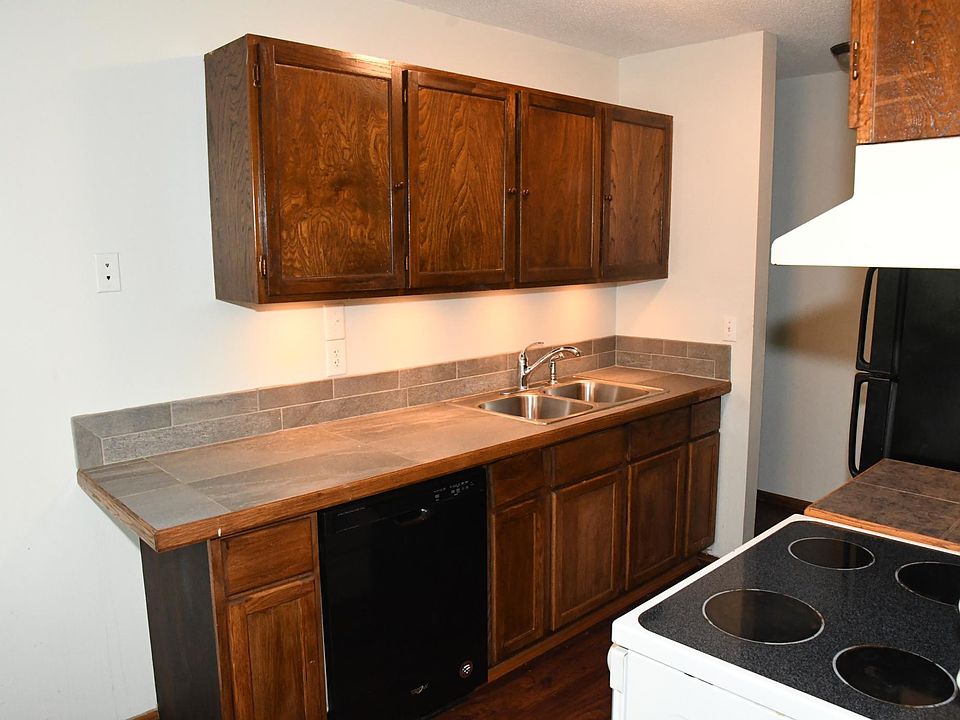 Kitchen has ceramic counter tops and stainless steel sink.