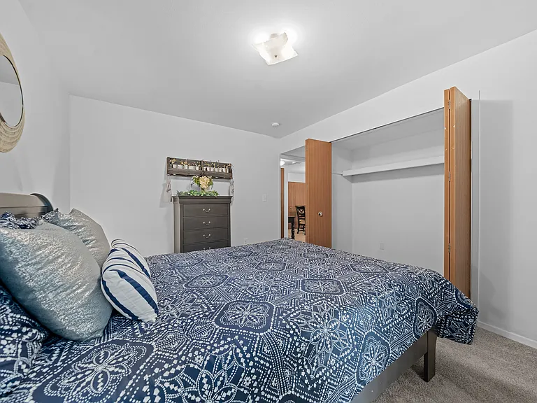 Comfortable bedroom with natural lighting at Westwood Village Apartments in Westland, MI