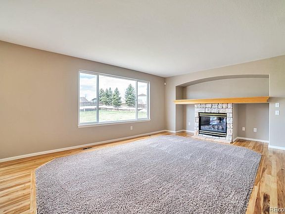 Cozy Family Room with Gas Fireplace and inset carpet.