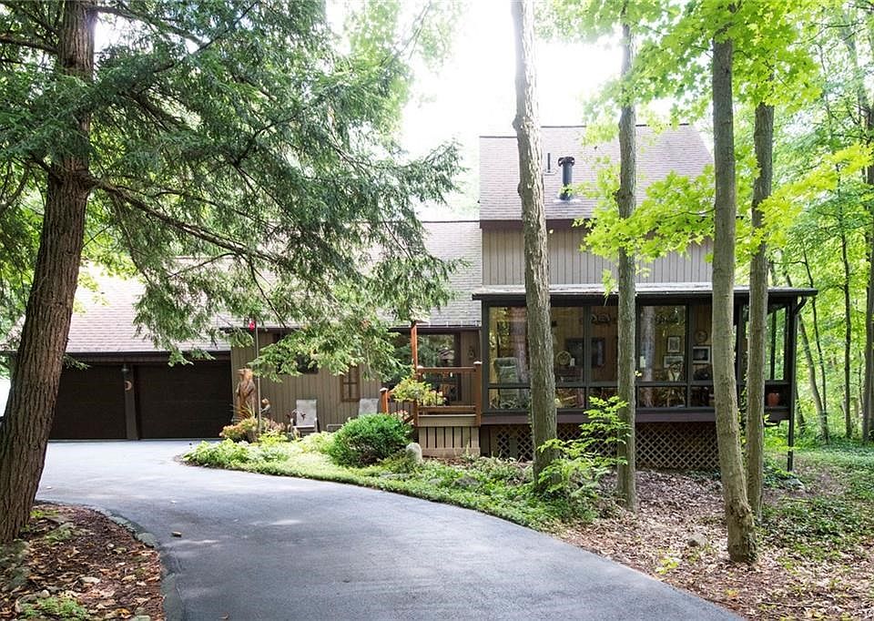 Circular driveway leads to private, treed retreat!
