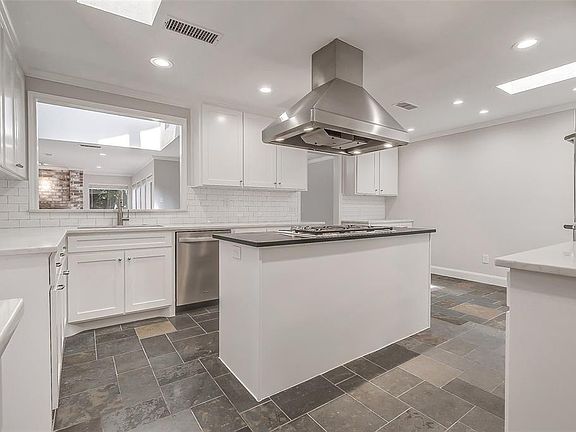 The kitchen is open to the living room and there is a single basin Quartz sink with a 3/4 HP Insinkerator disposal. There is also a pull out door made especially for the trash can.
