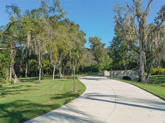 Private drive along the oaks, Florida plants and stone bridge will welcome you to this fabulous country estate.