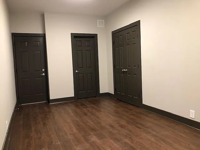 unfurnished, far left door connects to garage, middle door to full bathroom, far right doors to closet