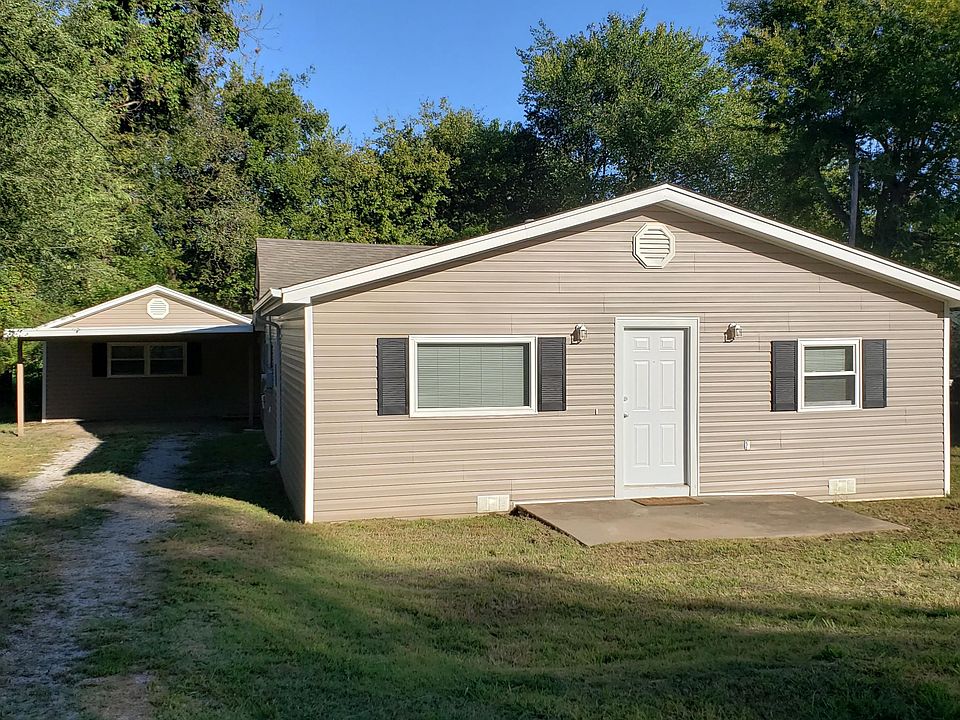 Front view from 1st Place with new siding, windows, roof, carport on spacious lot.