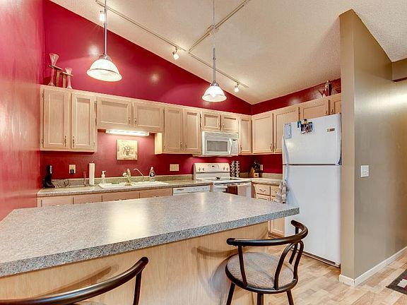 The kitchen/dining area feature a breakfast bar is perfect for quick meals on the go and added seating for guests.