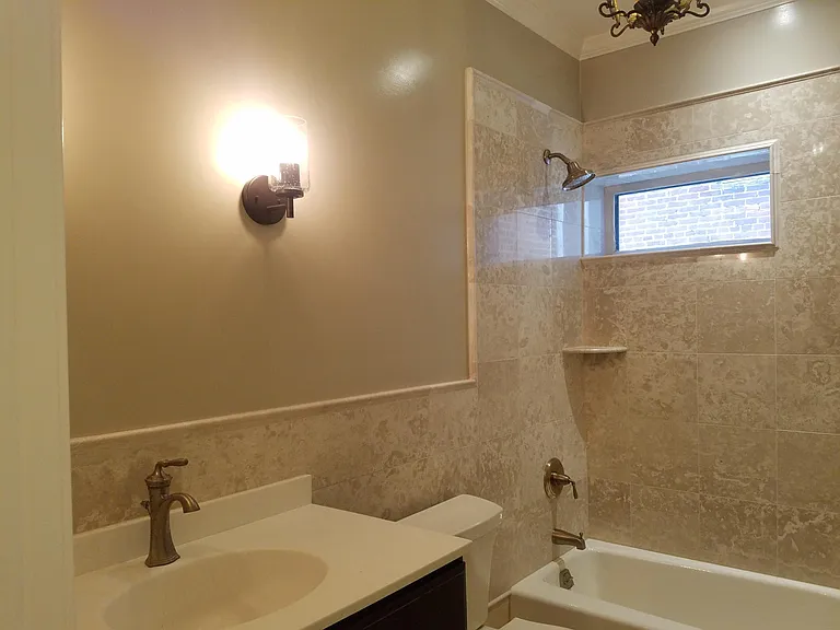 marble bathroom with shower tub. Mirror and medicine cabinet on order. Restored chandelier. Heated towel bar in each bathroom.