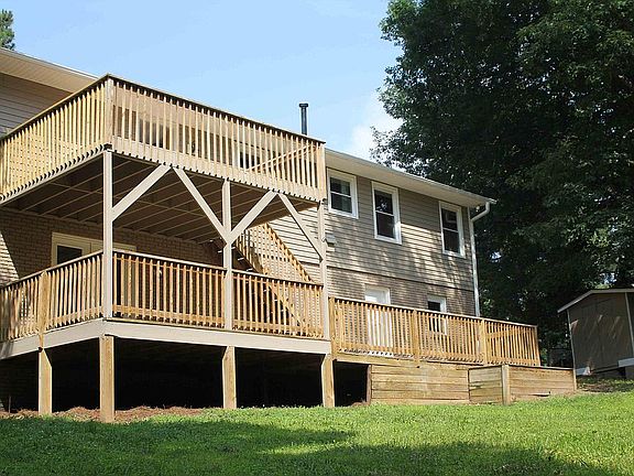 Large fenced backyard with multiple decks