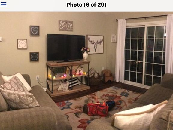 Living room sliders open to screaned porch overlooks lake