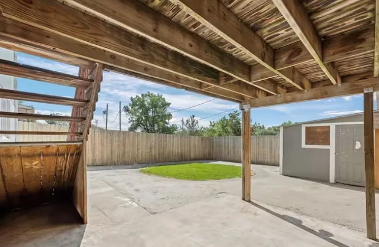 Walkout basement unit backyard with private shed. Exterior stairs join up/down units.