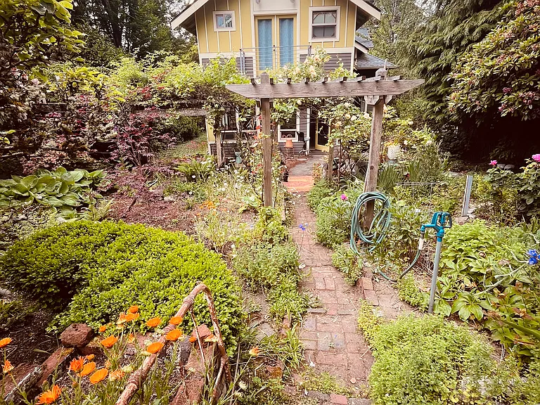 Private back yard. There is also a paved walkway to the covered parking area in back.