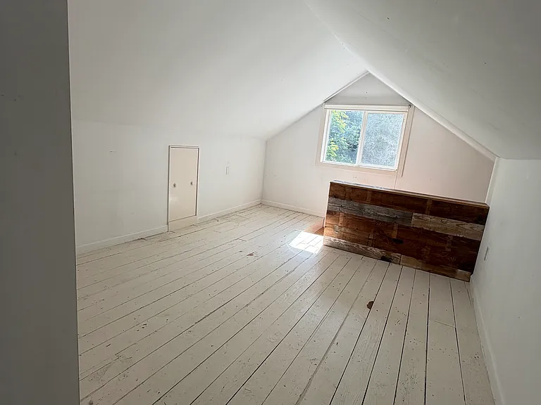 Upstairs bedroom faces the backyard. You must walk through this room to get to the front room but it is separated by a wall. This whole space could be used as 2 bedrooms.