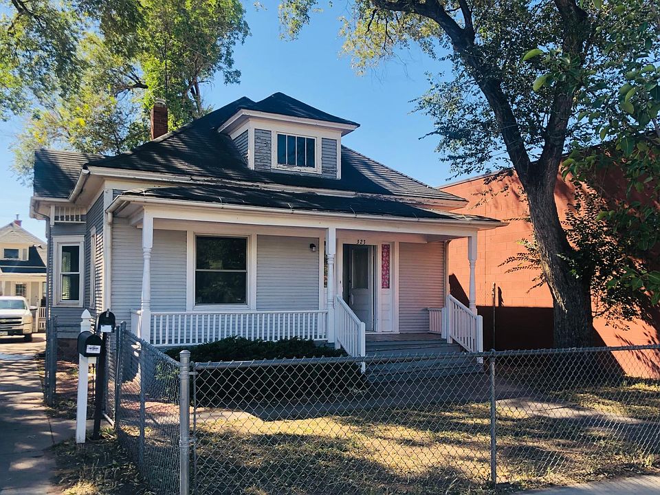 Front house with fenced yards and of street driveway