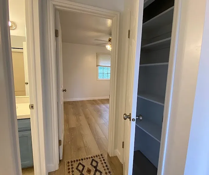 Upstairs hall outside primary bedroom and full bathroom. Linen closet.