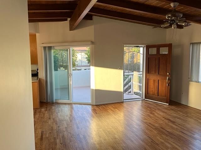 View of living room and sliding glass door to deck