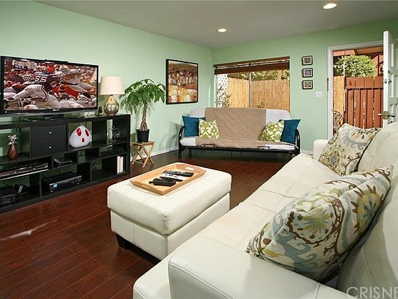 A classic paneled front door opens to a bright, flowing open concept floor plan with a designer pain