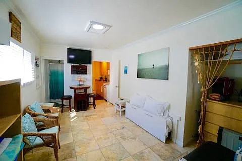 Mounted TV, closet space, sitting areas, ensuite bathroom and little kitchen