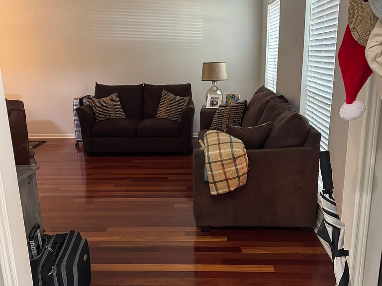 Living room with hardwood floor, can be used as office space