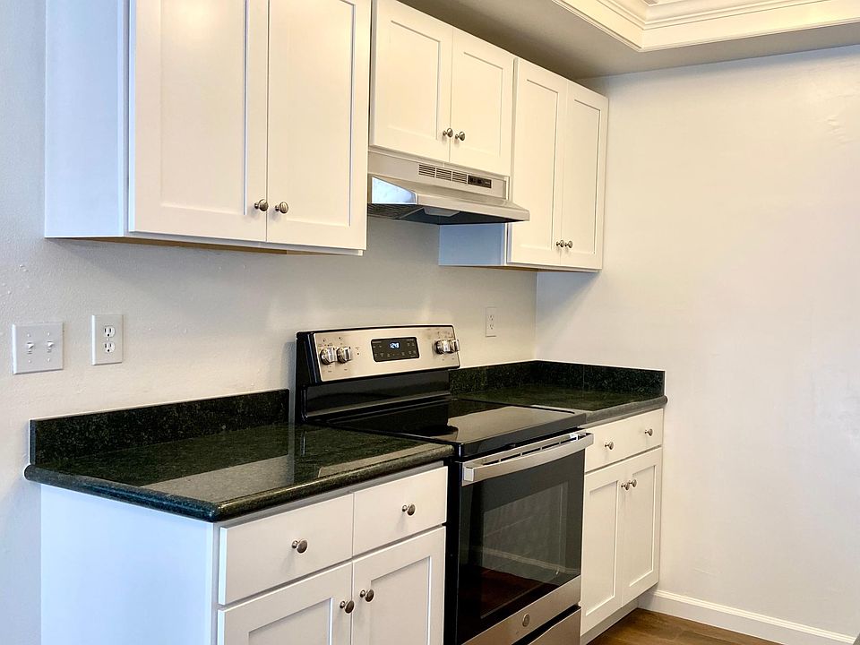 New convection stove and oven, cabinetry, granite countertops, and flooring.