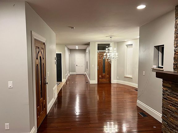 Standing in Living Room. Door on Left is second entrance into apartment. Dining area to the right. Kitchen to the left. Bed Rooms at the end of hallway.