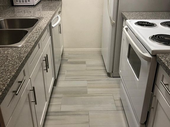 Kitchen with new cabinets featuring new tile