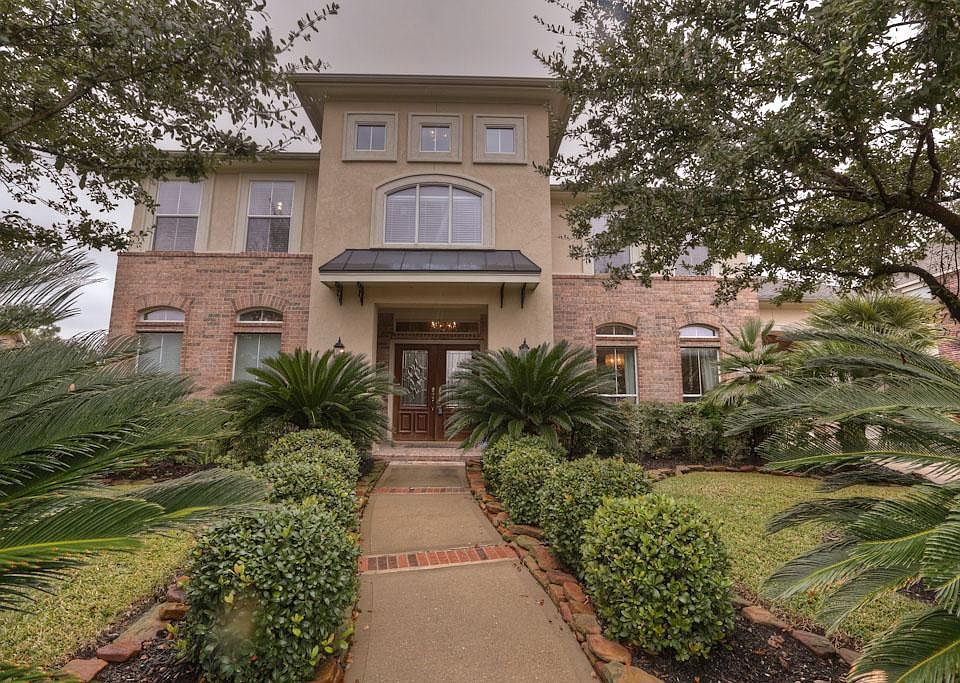 Lush landscaping as you draw near to the double door entry.