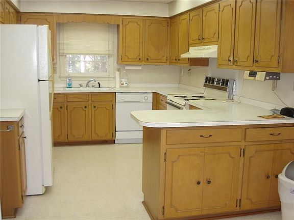 Nice spacious kitchen with lots of cabinets. Place for bar stools at bar area and also breakfast area approx. 7.8x 9. Kitchen size 11.6x11.2 plus breakfast area. Currently the laundry is in the kitchen area in a closet.