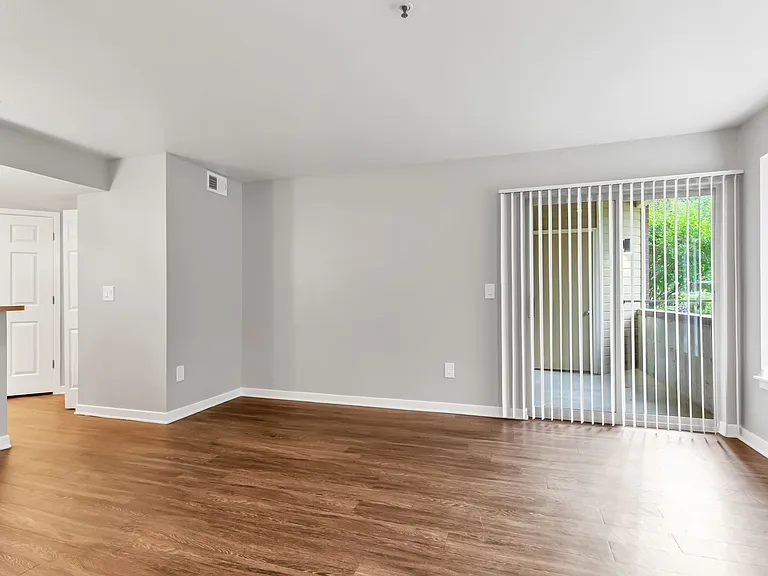 A Living Room with a view of the Patio/Balcony at The Buttes Apartment Homes in Loveland, CO