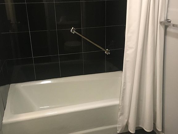 Full tub. Granite flooring and tub surround