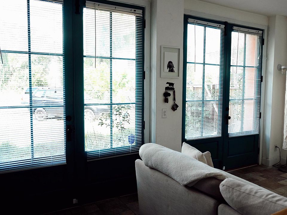 French doors full function for an open breezeway/living room. Blinds are removable for added natural light.