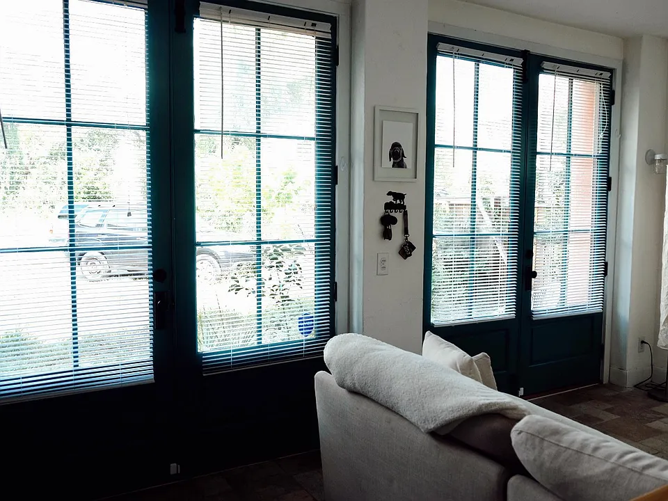 French doors full function for an open breezeway/living room. Blinds are removable for added natural light.