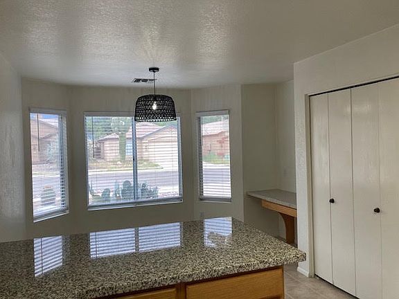 View of kitchen bay window and seating area.
