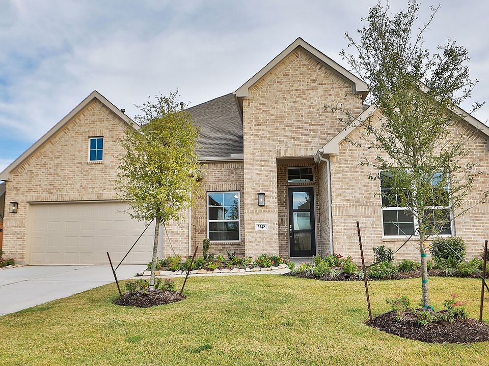 Experience refined living in this exquisite brick facade home in Tulane at Sunterra. Classic eleganc